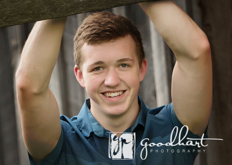 Senior Guy leaning on fence